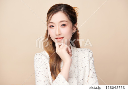 Beautiful young asian woman with clean fresh skin on beige background, Face care, Facial treatment, Cosmetology, beauty and spa, Asian women portrait. Beautiful young asian woman with clean fresh skin on beige background, Face care, Facial treatment, Cosmetology, beauty and spa, Asian women portrait. 118048738