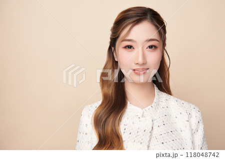 Beautiful young asian woman with clean fresh skin on beige background, Face care, Facial treatment, Cosmetology, beauty and spa, Asian women portrait. 118048742