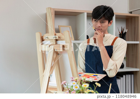 Artist contemplating ideas for artwork at home 118048946