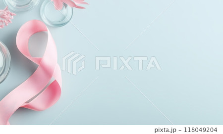 Pink Ribbon Entwined With Laboratory Glassware On A Solid Background Pink Ribbon Entwined With Laboratory Glassware On A Solid Background 118049204