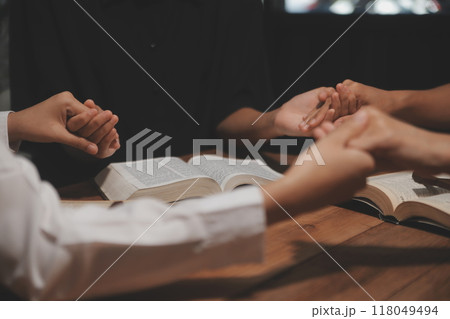 Christian group are praying to god with the bible and sharing the gospel. Concept of faith for god. Christian group are praying to god with the bible and sharing the gospel. Concept of faith for god. 118049494