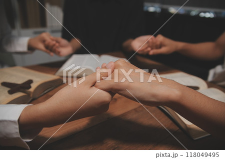 Christian group are praying to god with the bible and sharing the gospel. Concept of faith for god. Christian group are praying to god with the bible and sharing the gospel. Concept of faith for god. 118049495