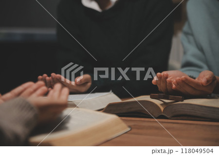 Christian group are praying to god with the bible and sharing the gospel. Concept of faith for god. Christian group are praying to god with the bible and sharing the gospel. Concept of faith for god. 118049504