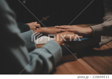 Christian group are praying to god with the bible and sharing the gospel. Concept of faith for god. 118049511