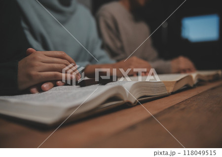 Christian group are praying to god with the bible and sharing the gospel. Concept of faith for god. Christian group are praying to god with the bible and sharing the gospel. Concept of faith for god. 118049515
