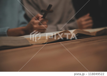 Christian group are praying to god with the bible and sharing the gospel. Concept of faith for god. Christian group are praying to god with the bible and sharing the gospel. Concept of faith for god. 118049522
