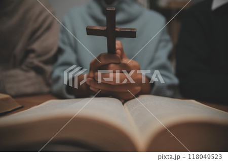 Christian group are praying to god with the bible and sharing the gospel. Concept of faith for god. 118049523