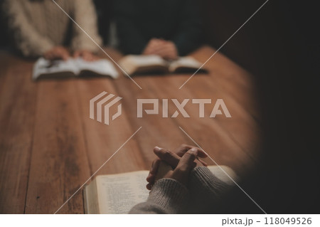 Christian group are praying to god with the bible and sharing the gospel. Concept of faith for god. Christian group are praying to god with the bible and sharing the gospel. Concept of faith for god. 118049526