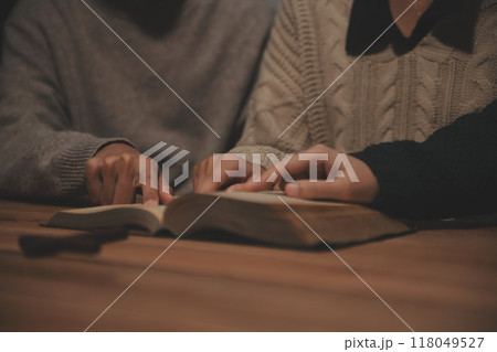 Christian group are praying to god with the bible and sharing the gospel. Concept of faith for god. Christian group are praying to god with the bible and sharing the gospel. Concept of faith for god. 118049527