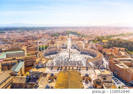 Visitors gather in Saint Peter's Square, marveling at the grandeur of St. Peter's Basilica and enjoying the scenic beauty of Vatican City during a serene sunset Visitors gather in Saint Peter's Square, marveling at the grandeur of St. Peter's Basilica and enjoying the scenic beauty of Vatican City during a serene sunset 118052840