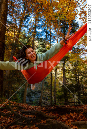 Relaxing in a Hammock in Autumn Forest Relaxing in a Hammock in Autumn Forest 118053207