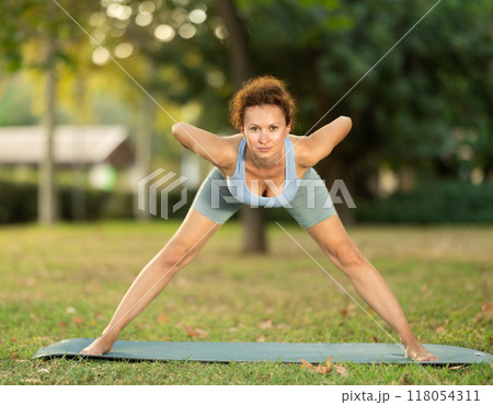 Adult woman doing yoga in park 118054311