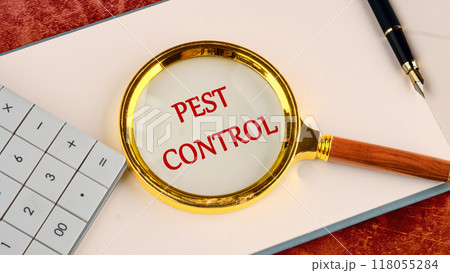 Pest control phrase written through a magnifying glass in red letters in a notebook on a blank sheet 118055284