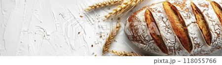 A freshly baked bread loaf made with wheat flour sits on a white background with wheat stalks. Generative AI 118055766