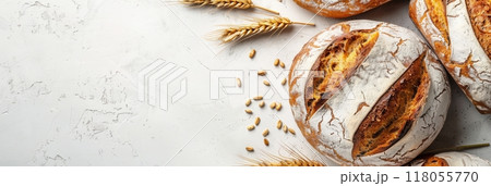 A freshly baked wheat bread loaf with wheat grains on a white background. Generative AI 118055770