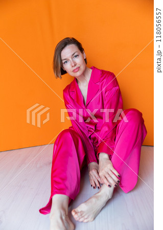 Beautiful woman in pink silk fashion pajamas 118056557