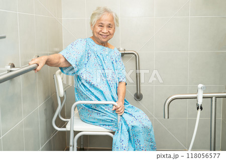 Asian elderly woman patient use toilet bathroom handle security in nursing hospital, healthy strong medical concept. 118056577