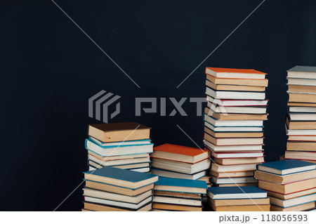 lots of stacks of old vintage books to study in the library on a black background lots of stacks of old vintage books to study in the library on a black background 118056593