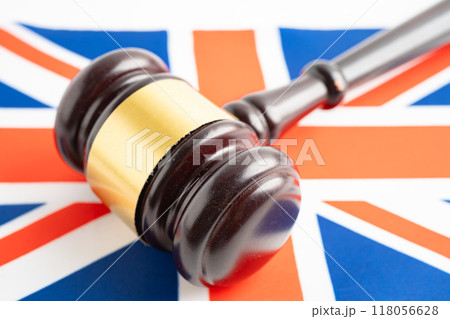 United Kingdom for judge lawyer and US dollar banknotes on USA America flag, finance concept. United Kingdom for judge lawyer and US dollar banknotes on USA America flag, finance concept. 118056628