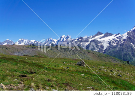 mountain landscape with alpine meadow, observatory in the distance and mountain peaks in the background 118058189