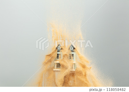 Strong wind of sand attack house with insurance create loss damage environment. Sand storm hit House as natural disaster from climate change global warming. Gray background isolated 118058482