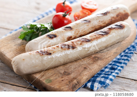 Grilled bratwurst sausages with tomatoes on wooden tabke Grilled bratwurst sausages with tomatoes on wooden tabke 118058680