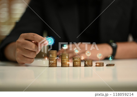 Businessman stacking coins in ascending order representing financial growth and savings goals Businessman stacking coins in ascending order representing financial growth and savings goals 118059214