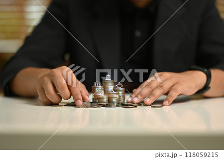A man is playing a game with coins on a table A man is playing a game with coins on a table 118059215