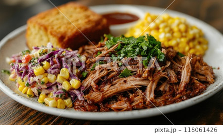 Delicious bbq pulled pork being served with cornbread and side dishes Delicious bbq pulled pork being served with cornbread and side dishes 118061426