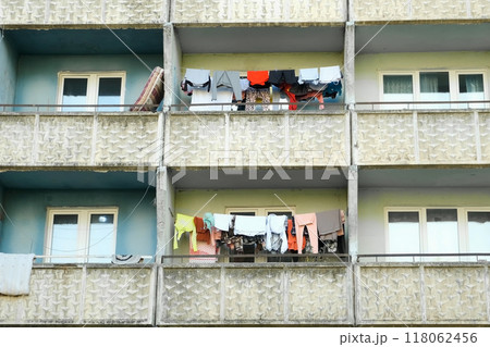 Balconies of panel building in ghetto with clothes hanging on ropes and drying. 118062456