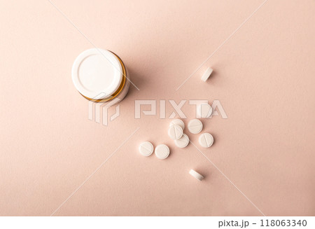 Pills and medical jar on pink background top wiev. Medicine dose. Concept of medicinal treatment, vitamins, antibiotic, supplements, contraceptive pills. Womens health banner. High quality photo 118063340