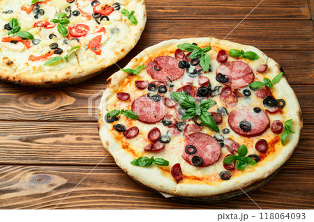 2 pizza with mozzarella cheese , salami sausages , olives , chicken , pineapple and tomatoes 2 pizza with mozzarella cheese , salami sausages , olives , chicken , pineapple and tomatoes 118064093