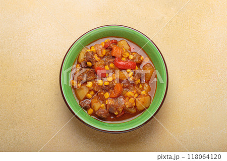 Carbonada Criolla, Argentinian beef casserole stew in bowl with serving spoon top view Carbonada Criolla, Argentinian beef casserole stew in bowl with serving spoon top view 118064120