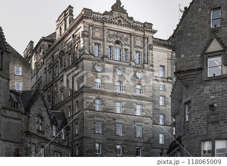 Charming facade of The Scotsman Hotel and ancient stone buildings in Baronial style on Cockburn Street. 118065009