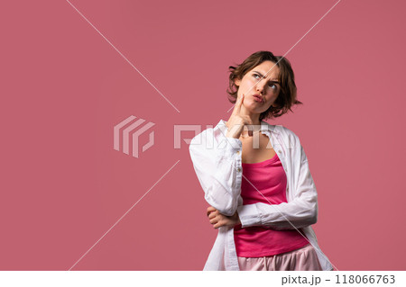 Thinking around stylish woman on pink background. Puzzled lady looking answer. Copy space. Thinking around stylish woman on pink background. Puzzled lady looking answer. Copy space. 118066763