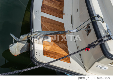 Yacht anchor close-up seen on the front of a vintage boat. Yacht anchor close-up seen on the front of a vintage boat. 118069709
