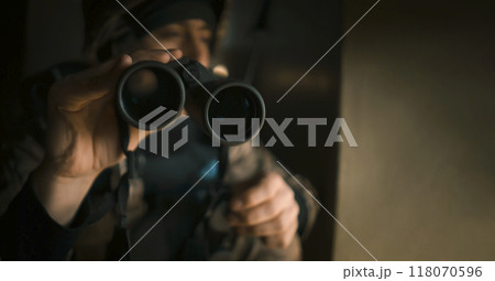 A Man with a binocular and in the military uniform. A Man with a binocular and in the military uniform. 118070596