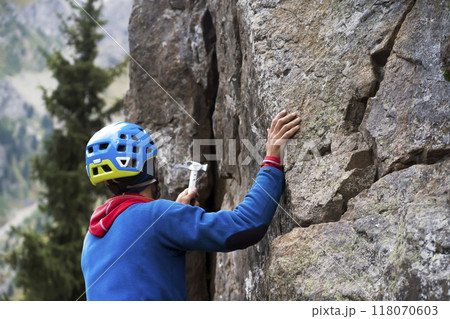 Man is climbing, hiking in the mountains. 118070603