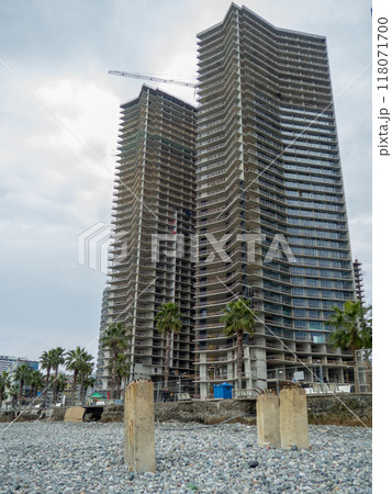 Reinforced concrete pile sticking out of the ground. Construction on the beach. Abandoned. Armature at sea. Destroyed building. Reinforced concrete pile sticking out of the ground. Construction on the beach. Abandoned. Armature at sea. Destroyed building. 118071700