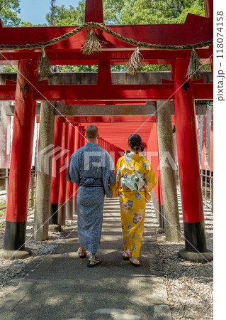 鳥居の連なる神社を散歩する浴衣姿の外国人カップル 118074158