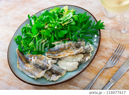 Fried cod fillet with herbs on plate 118077817