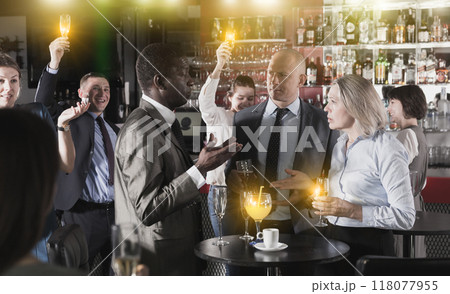 Three colleagues talking on party Three colleagues talking on party 118077955