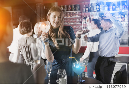 Girl drinking cocktail and dancing 118077989