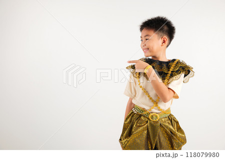 Portrait Thailand kid boy smiling traditional Thai dress costume indicate finger empty space, studio isolated white background, primary child pointing index out with copy space Portrait Thailand kid boy smiling traditional Thai dress costume indicate finger empty space, studio isolated white background, primary child pointing index out with copy space 118079980