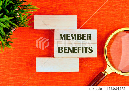 Conceptual member benefits symbol. Copy space. MEMBER BENEFITS message written on wooden blocks in a composition with a fragment of a magnifying glass and a plant Conceptual member benefits symbol. Copy space. MEMBER BENEFITS message written on wooden blocks in a composition with a fragment of a magnifying glass and a plant 118084481