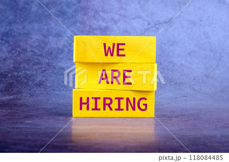 Business and Now Hiring concept. Copy space. Words WE ARE HIRING, It is made up of vertical blocks on an abstract background 118084485
