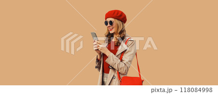 Autumn portrait of stylish happy smiling young woman with phone, beautiful girl holding smartphone 118084998