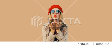 Autumn portrait beautiful young woman blowing a kiss in red french beret hat, stylish girl posing 118085002
