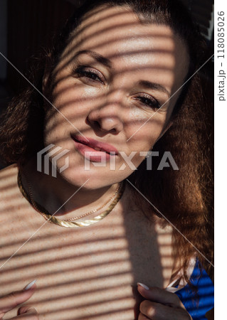 Beautiful woman window with blinds light and shadow Beautiful woman window with blinds light and shadow 118085026