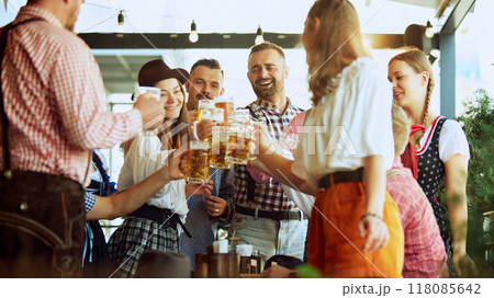 Traditional celebration of beer festival. Group of cheerful people, men and women at bar, drinking beer and having fun Traditional celebration of beer festival. Group of cheerful people, men and women at bar, drinking beer and having fun 118085642